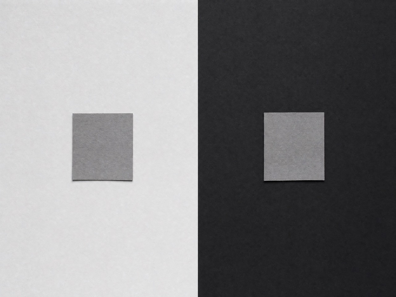 Two squares cut from one sheet of grey paper, on grounds of different lightness. They measure the same. Made for Percol.