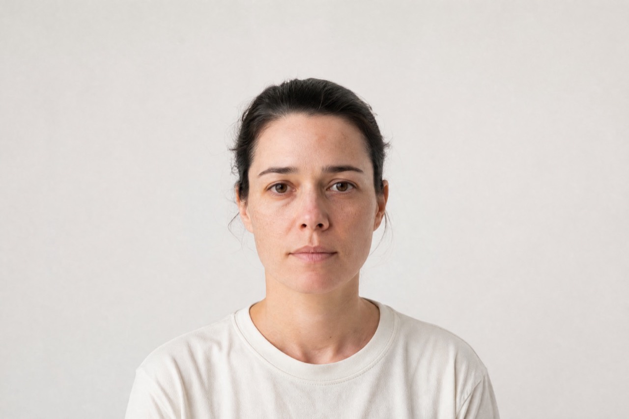 A bare face under even, indirect daylight against plain paper. Generated for Percol; not a photograph of a person, and not a photograph of an analysis.